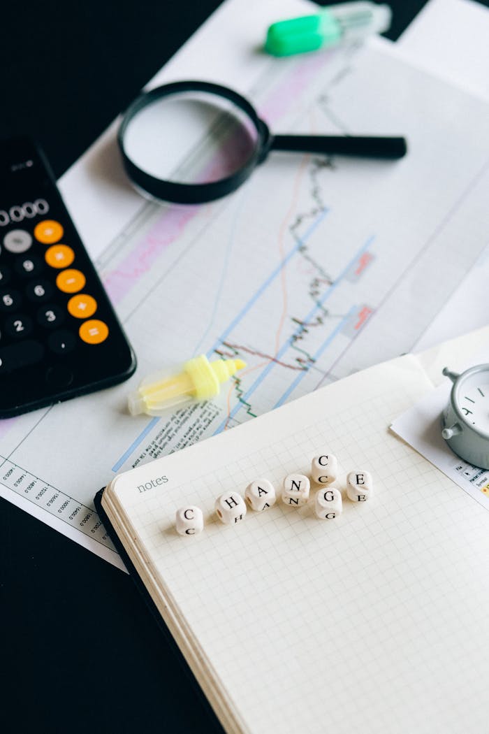 Mastering the First Impression: Your intriguing post title goes here Close-up of financial tools and letter blocks spelling 'CHANGE'.